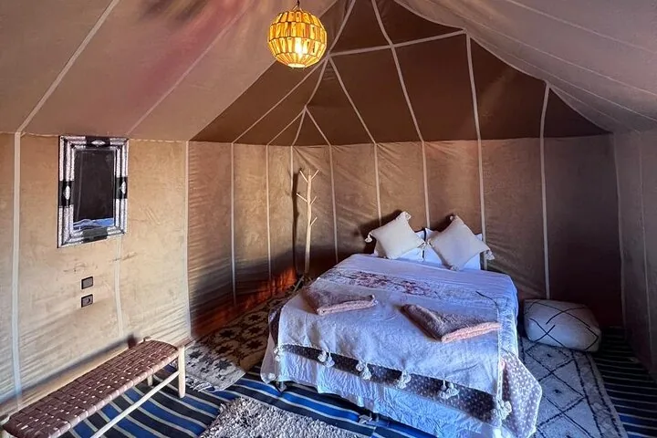 Interior of a comfortable desert tent with a double bed and decor